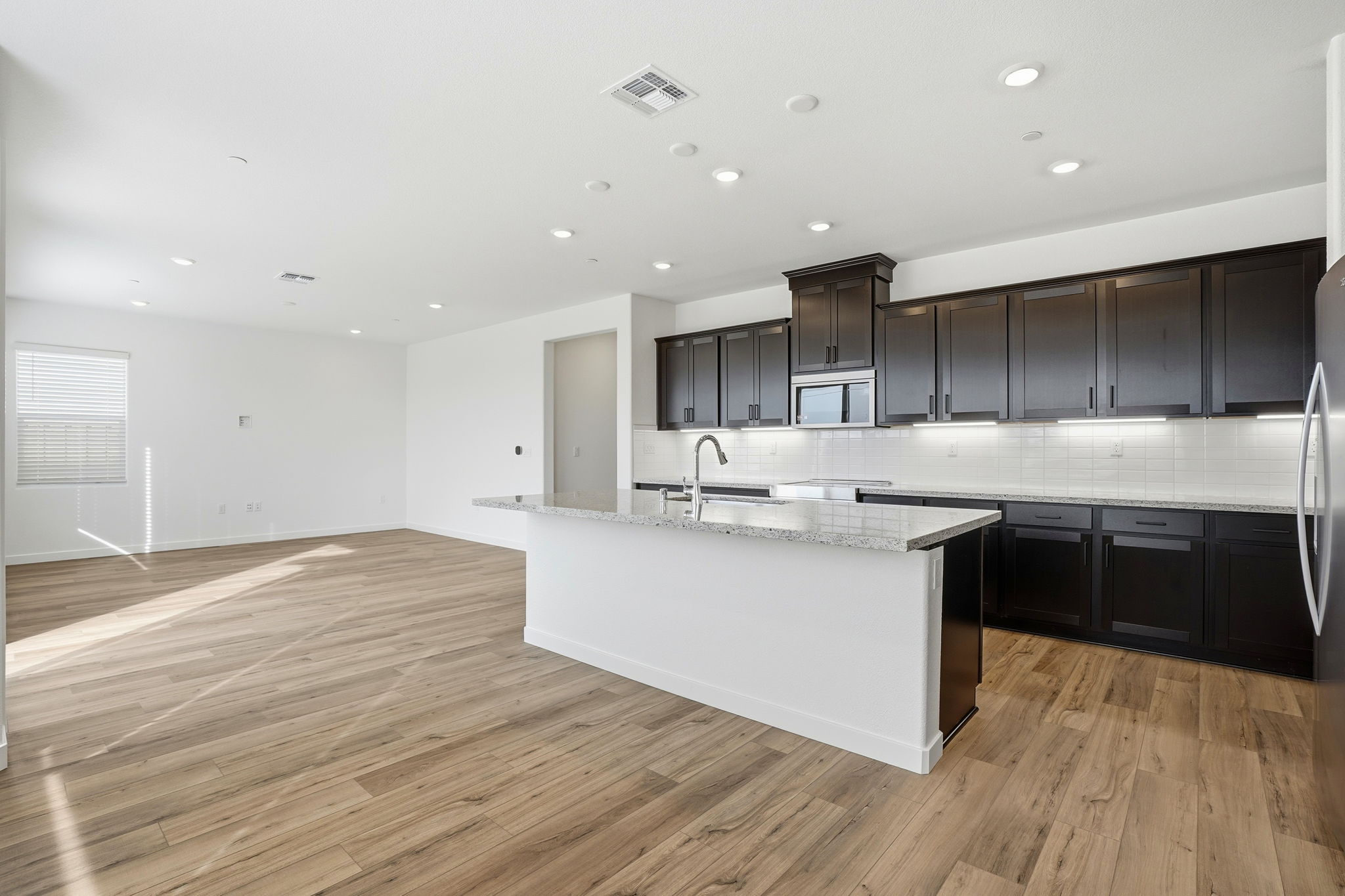 A kitchen with black cabinets.