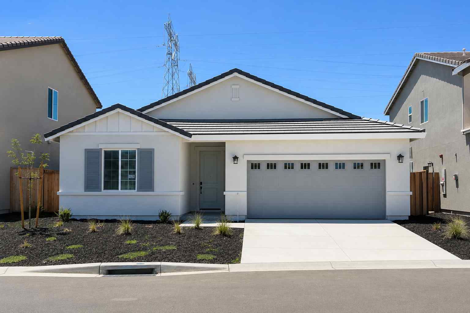 A white house with a garage.