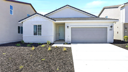 A white house with a garage.