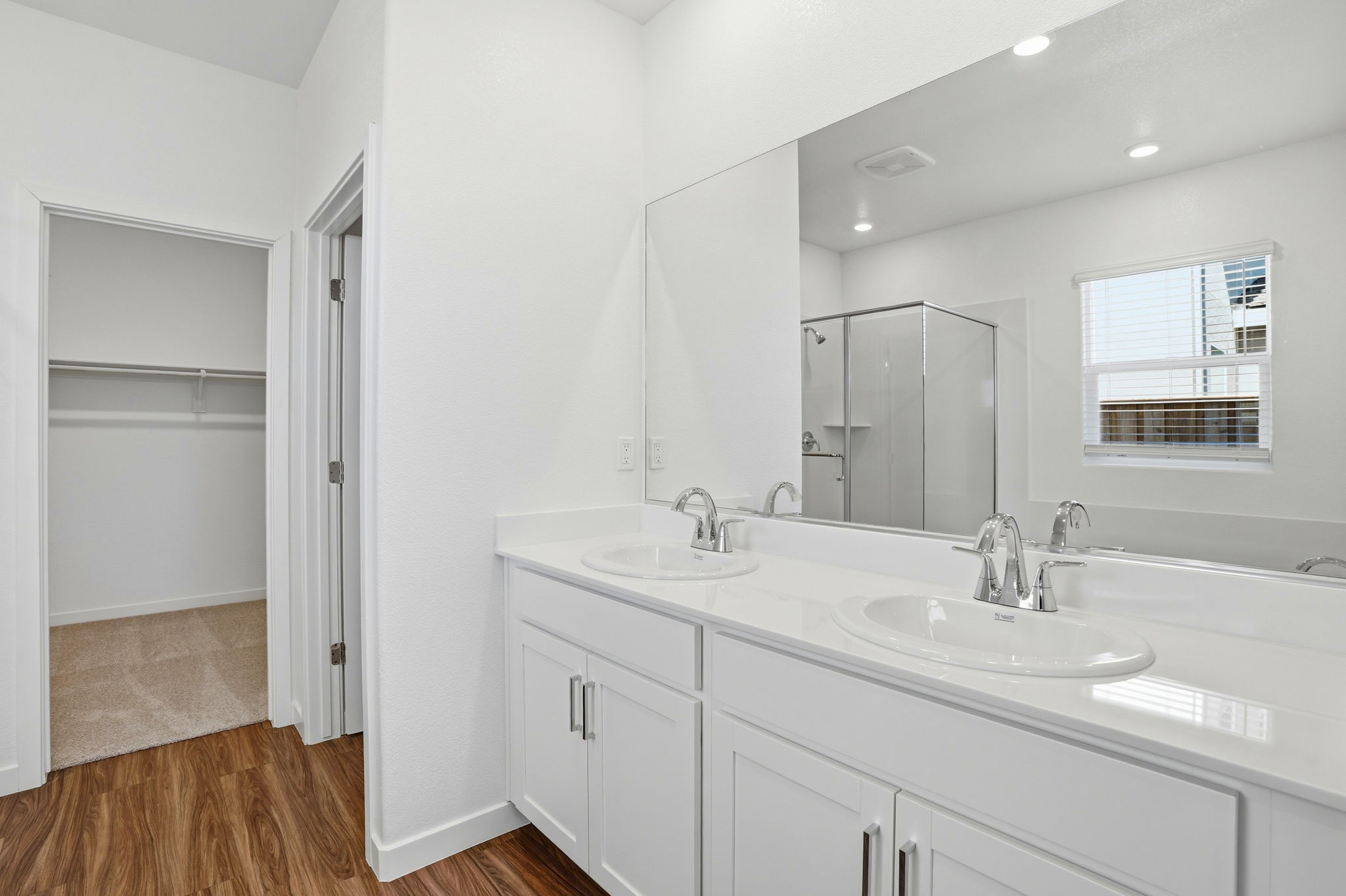 A bathroom with white cabinets.