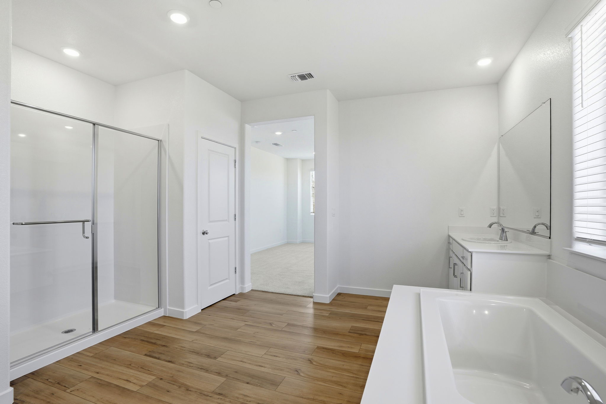 A bathroom with a tub and sink.