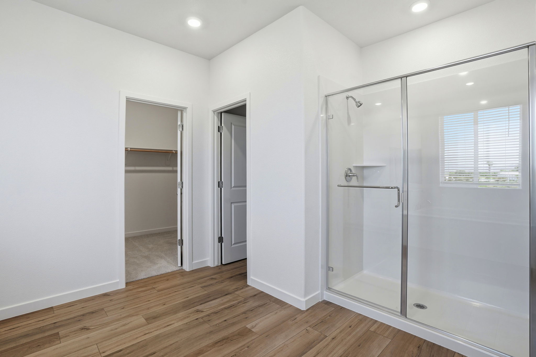 A bathroom with a glass shower.