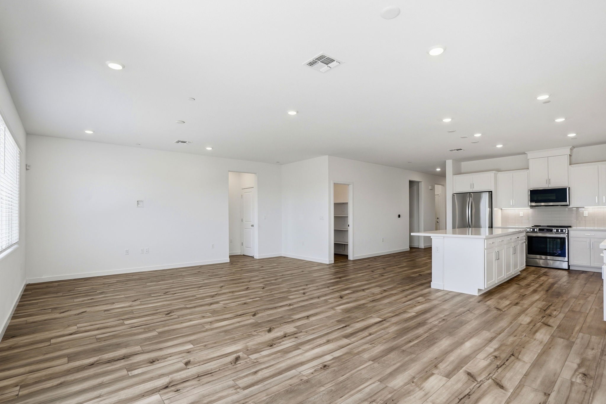 A large kitchen with white cabinets.