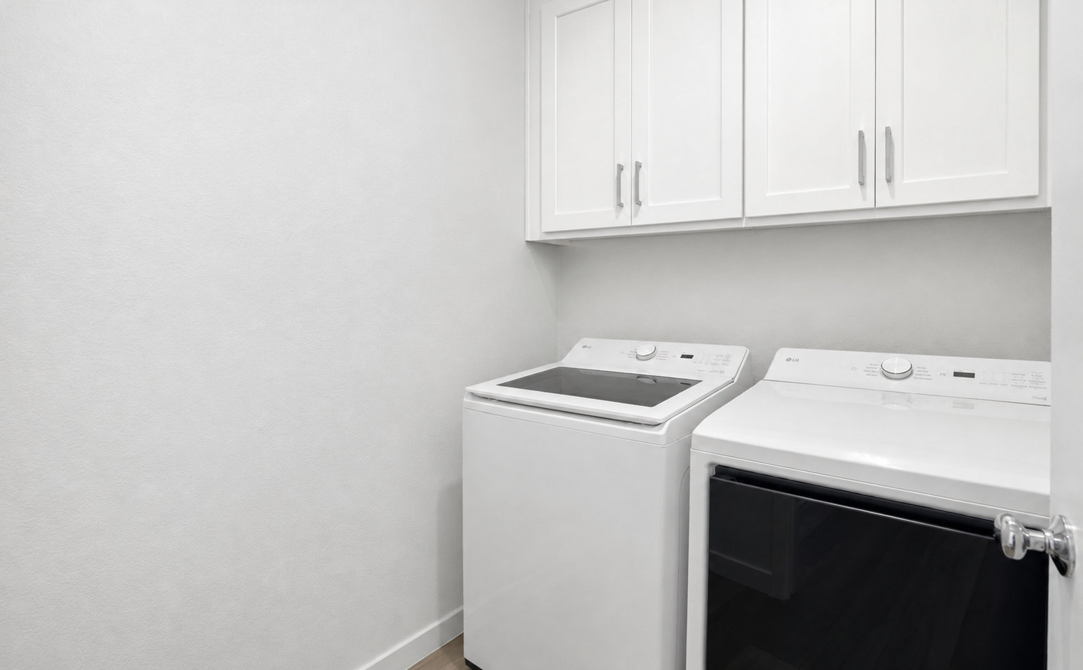 A white kitchen with white cabinets.