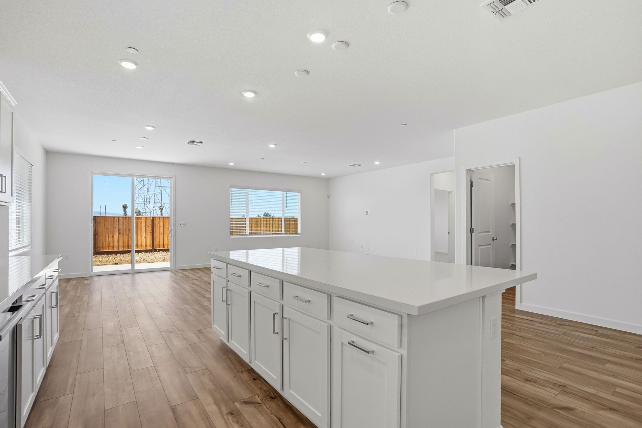 A kitchen with white cabinets.