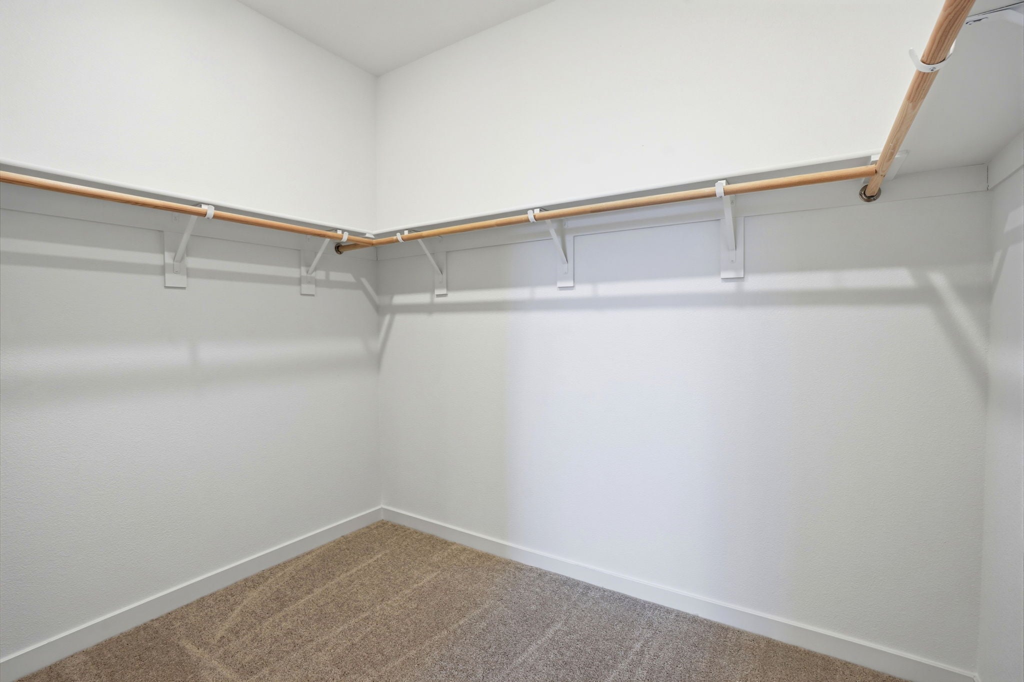 A white wall with a metal railing.
