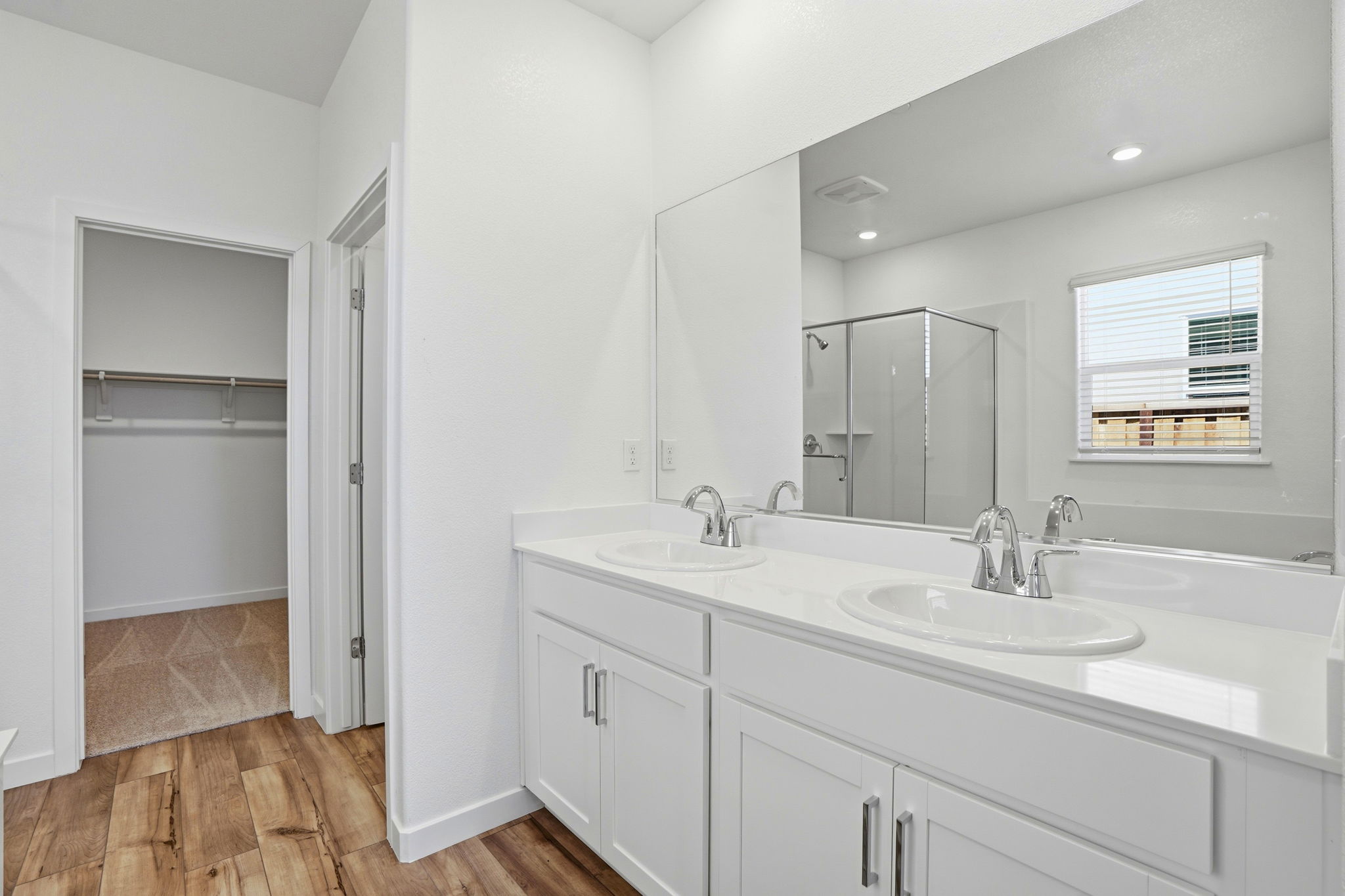 A bathroom with white cabinets.
