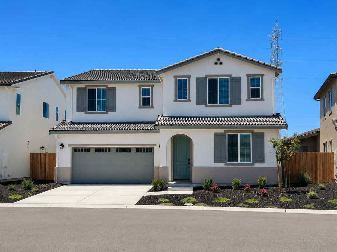 A white house with a garage.