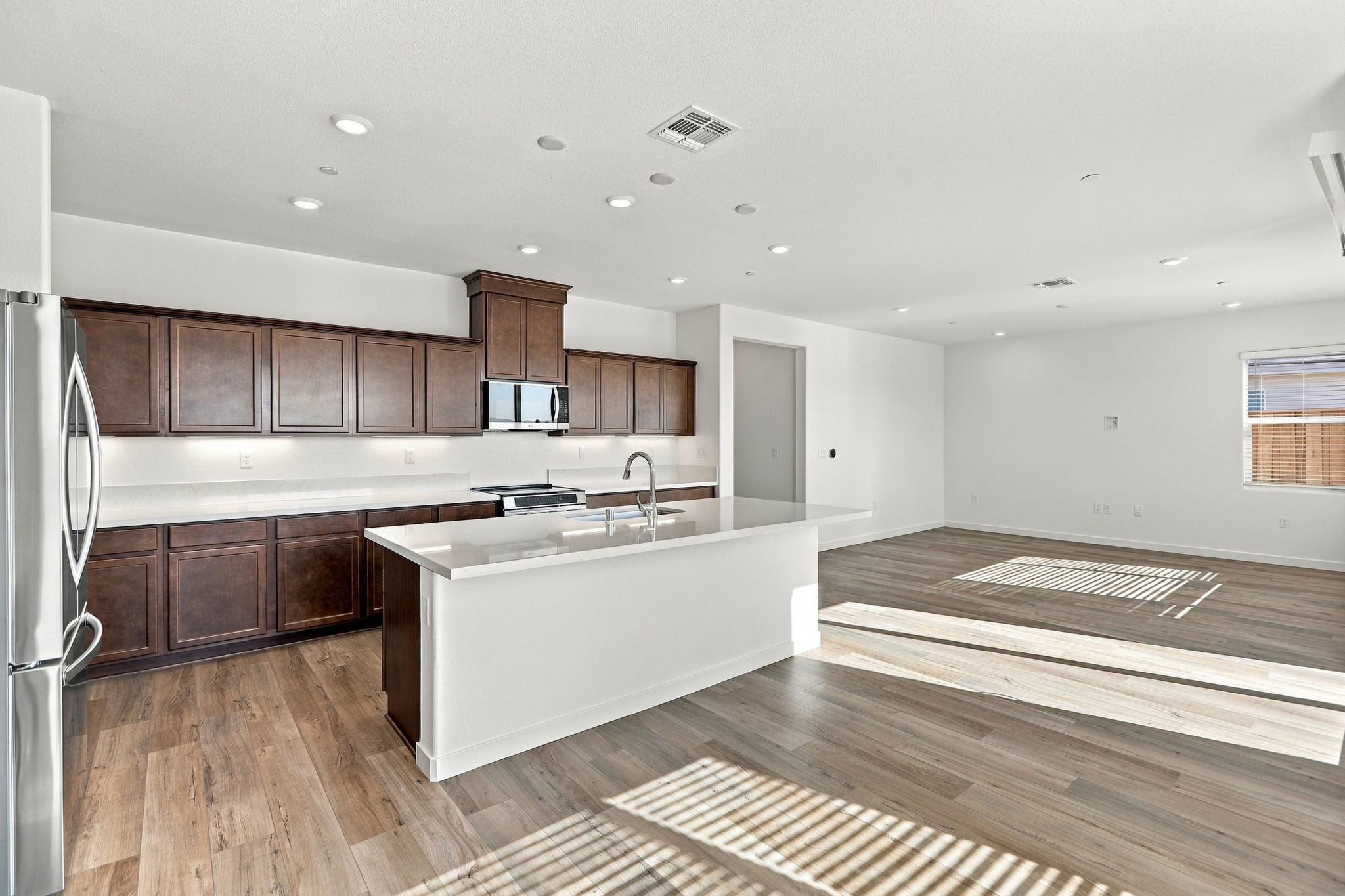 A kitchen with a wood floor.