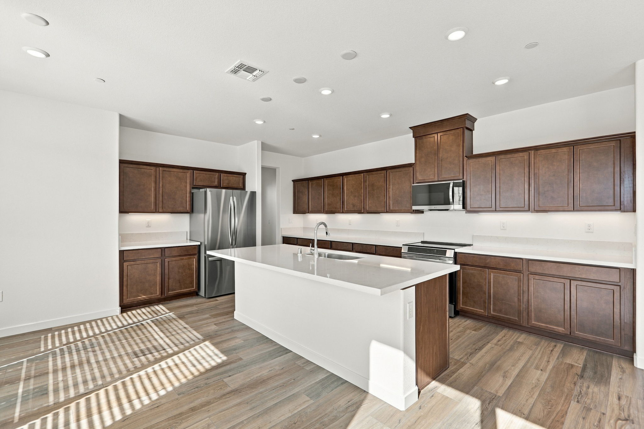 A kitchen with wooden cabinets.
