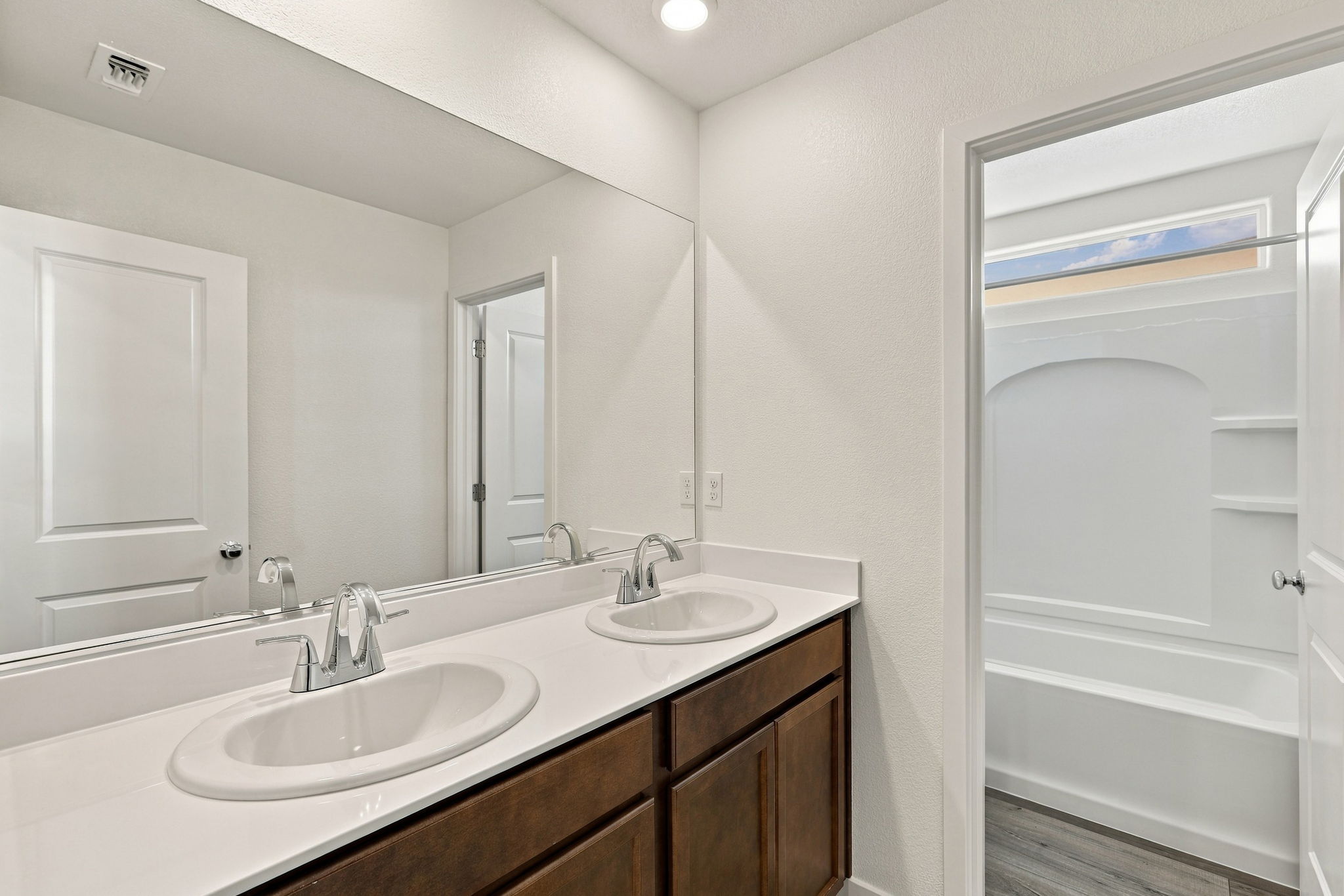 A bathroom with a large mirror.