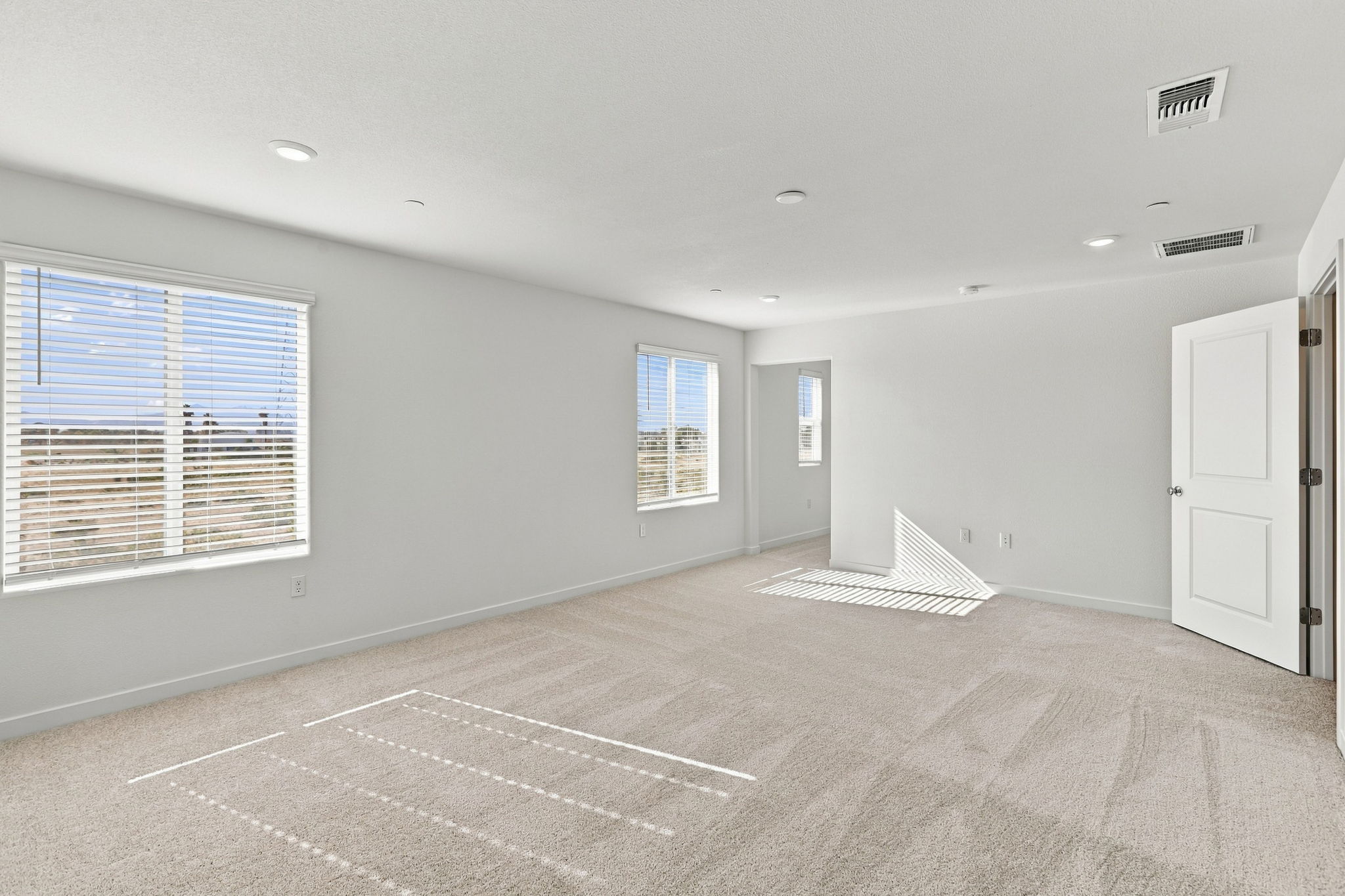 A room with white walls and windows.