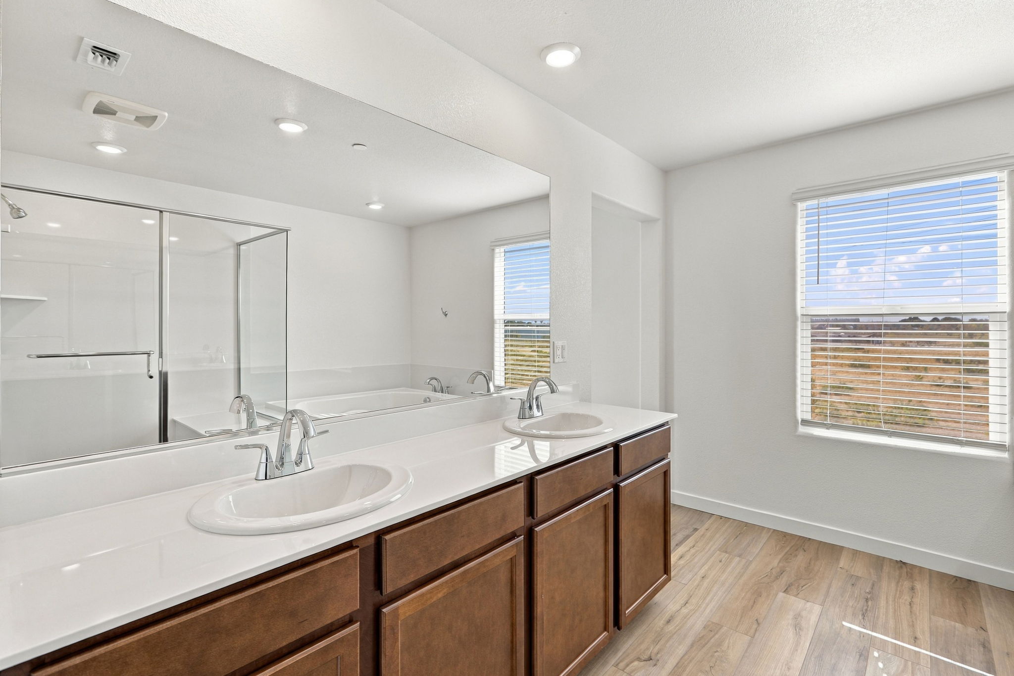 A bathroom with a large mirror.