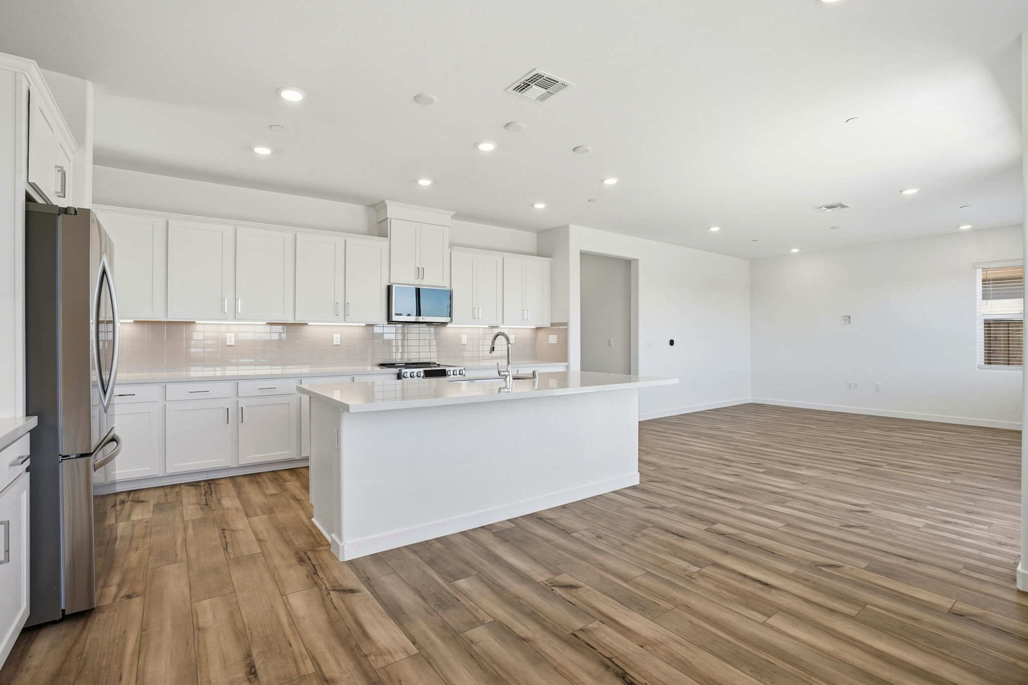 A kitchen with white cabinets.