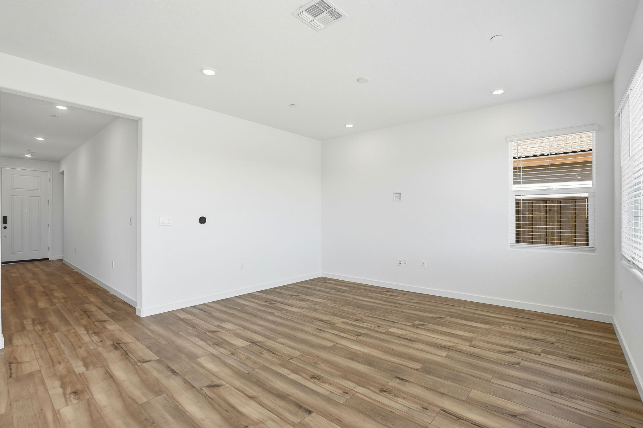 A room with a wood floor and white walls.