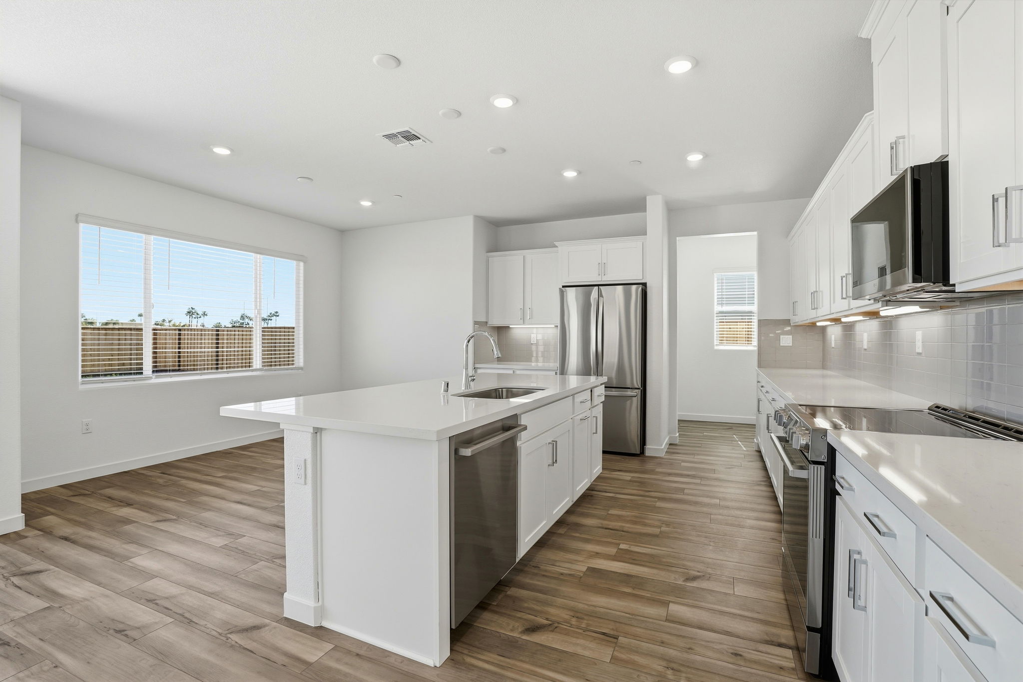 A kitchen with white cabinets.