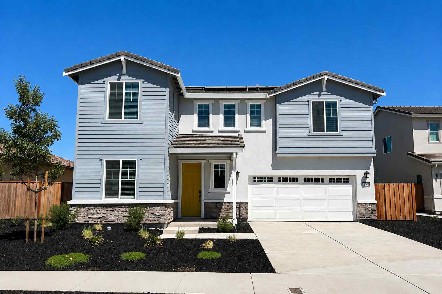 A white house with a garage.
