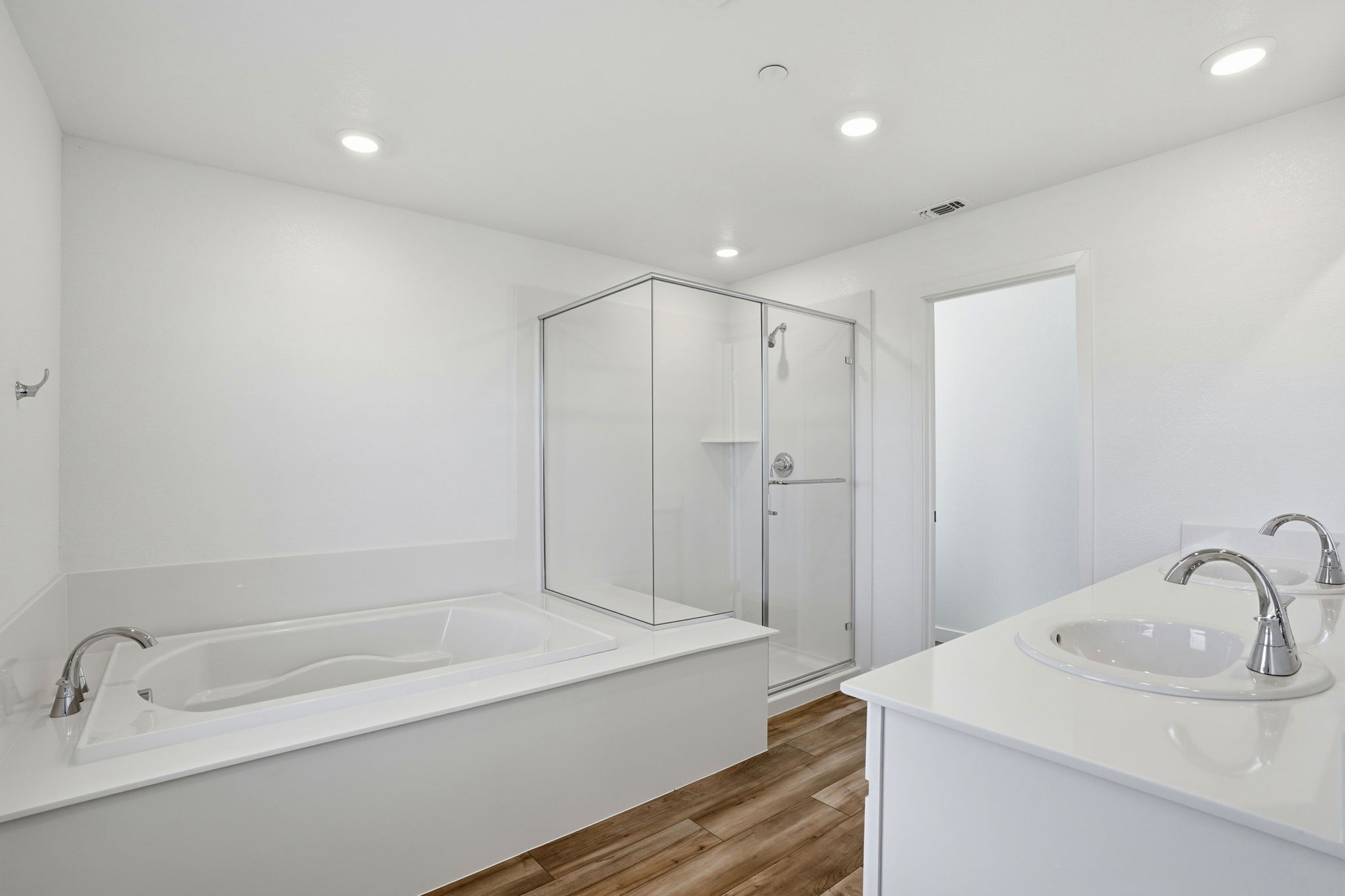 A bathroom with a tub sink and shower.