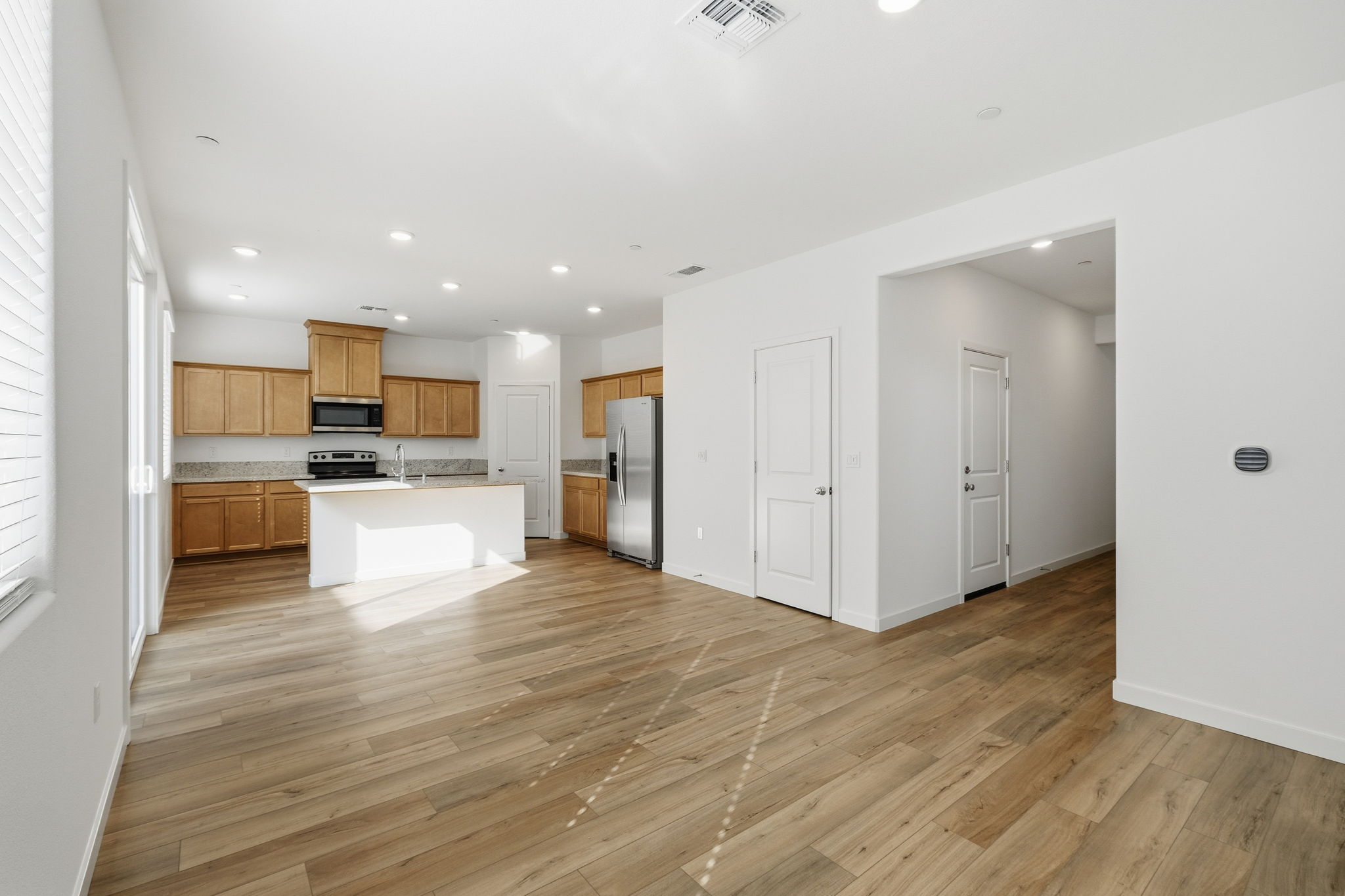 A large kitchen with wooden floors.