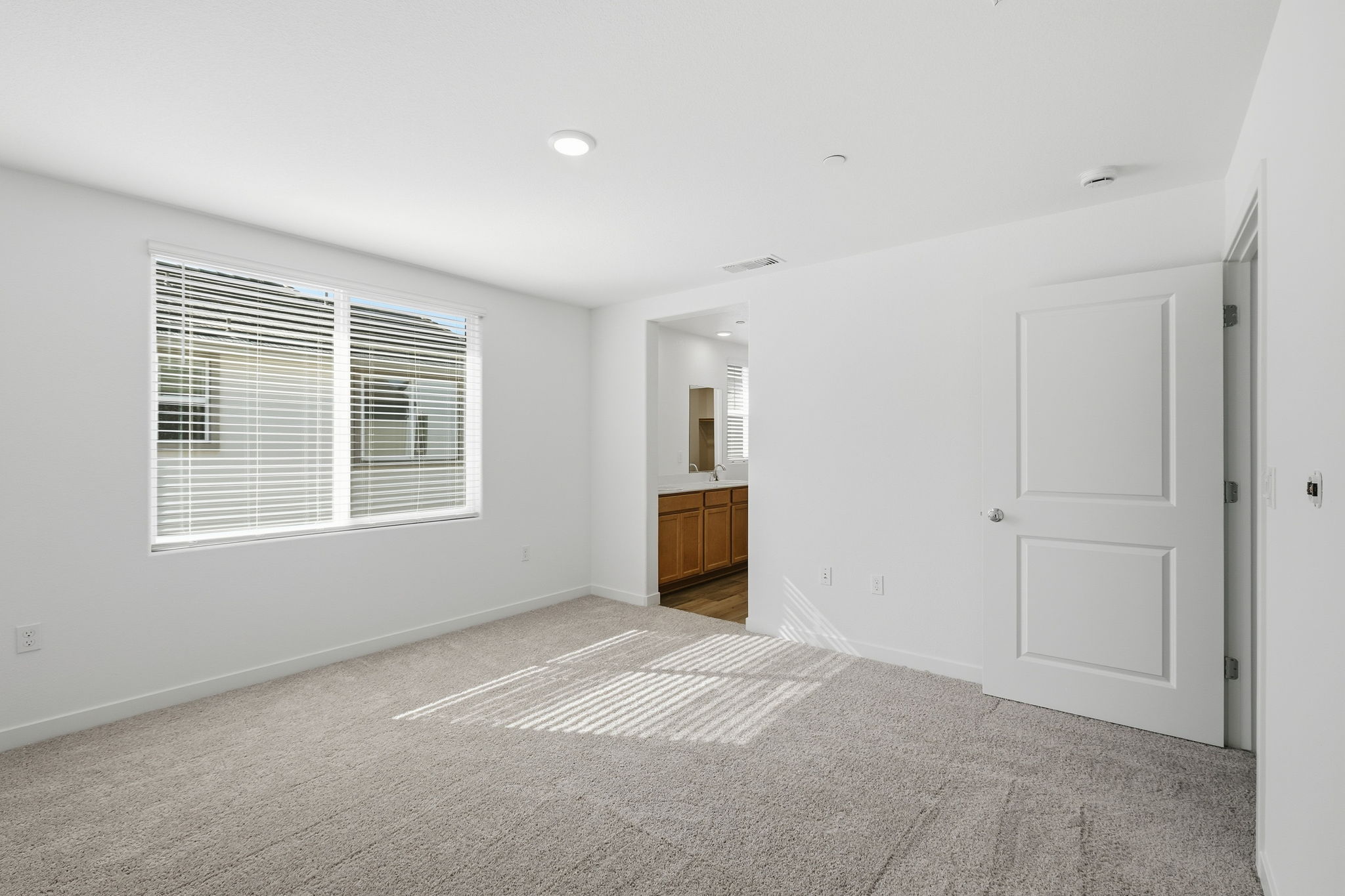 A room with white walls and a rug.