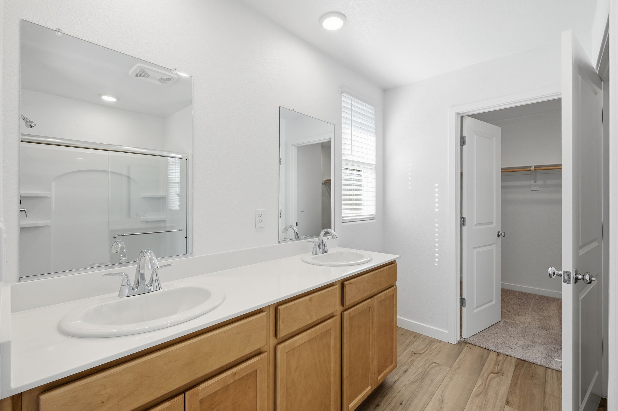A bathroom with a large mirror.