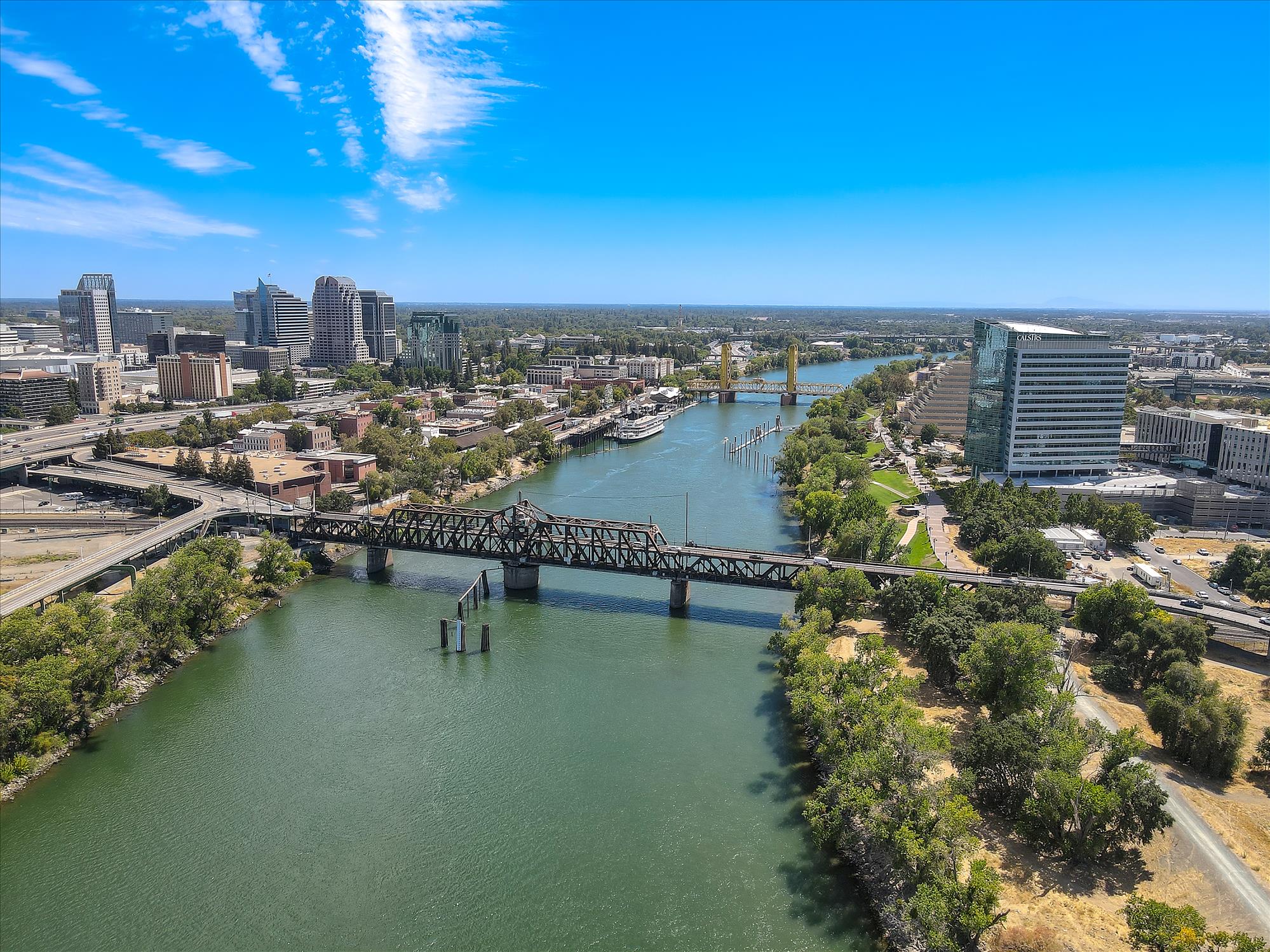 A body of water with a bridge and buildings around it.