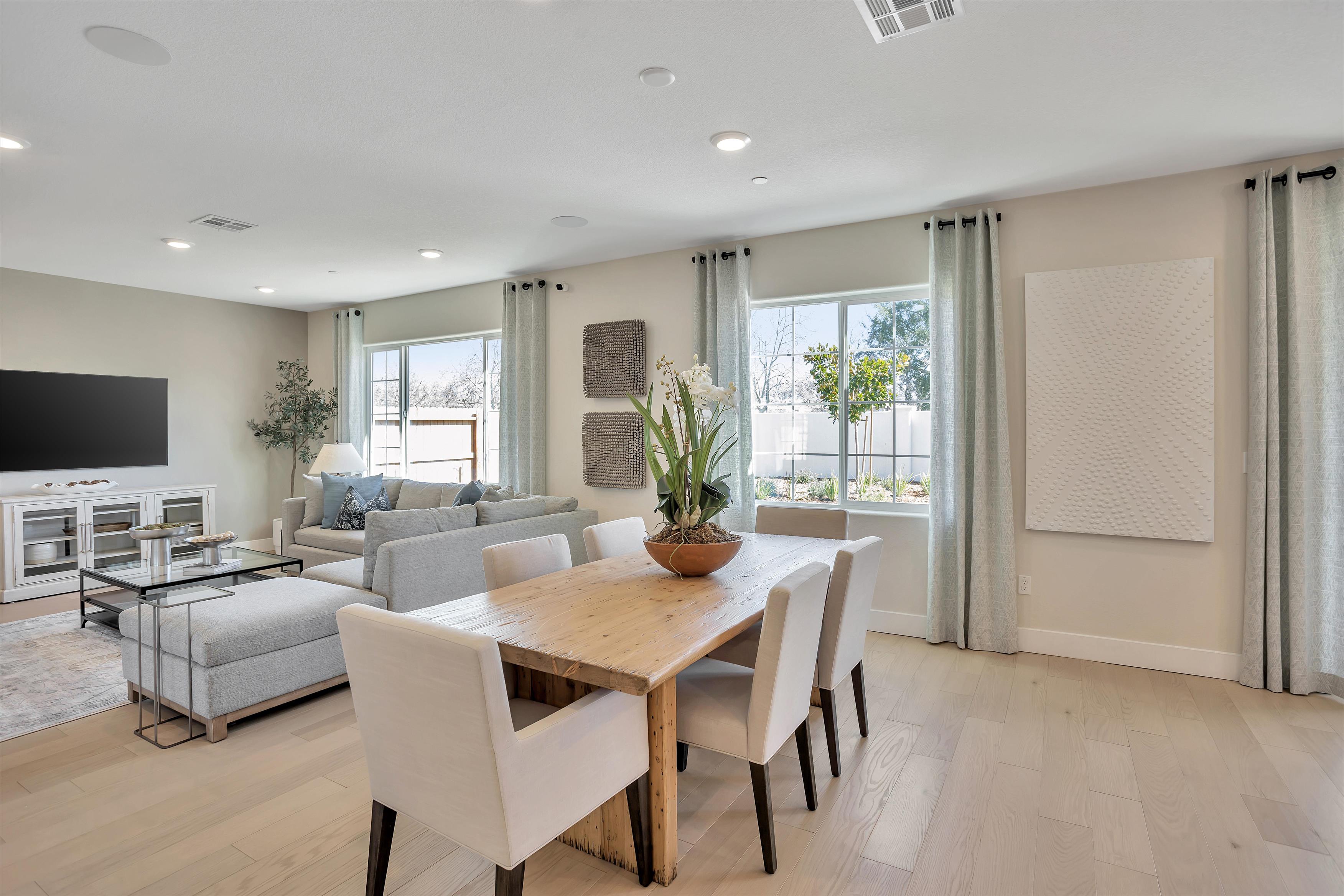 A living room with a table and chairs.