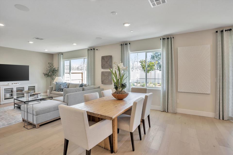 A living room with a table and chairs.