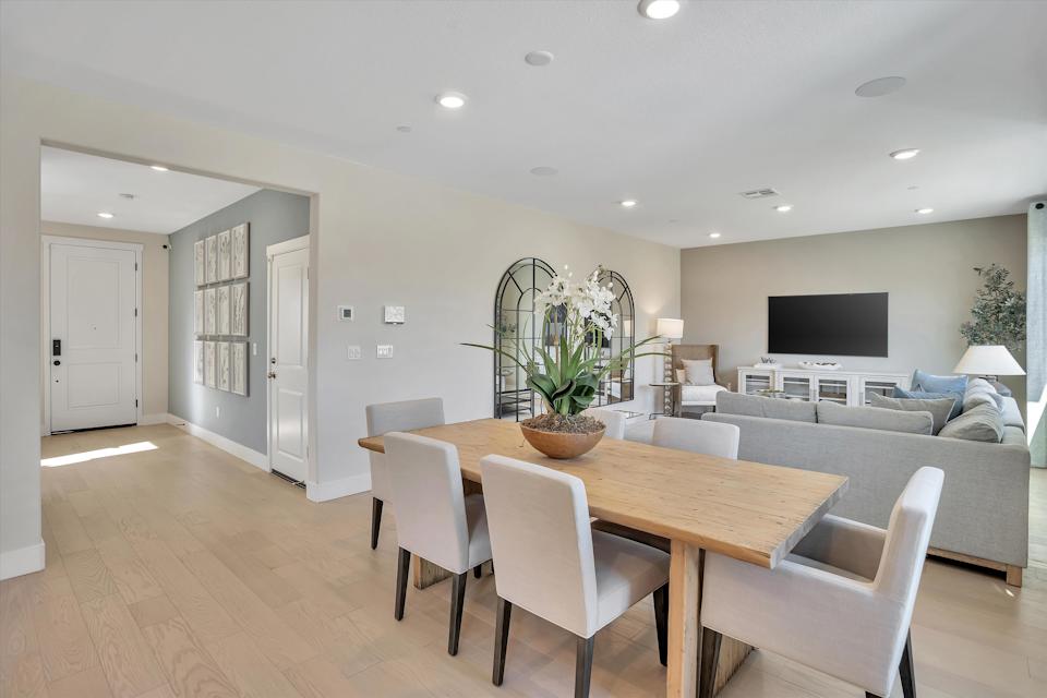 A large living room with a large table and chairs.