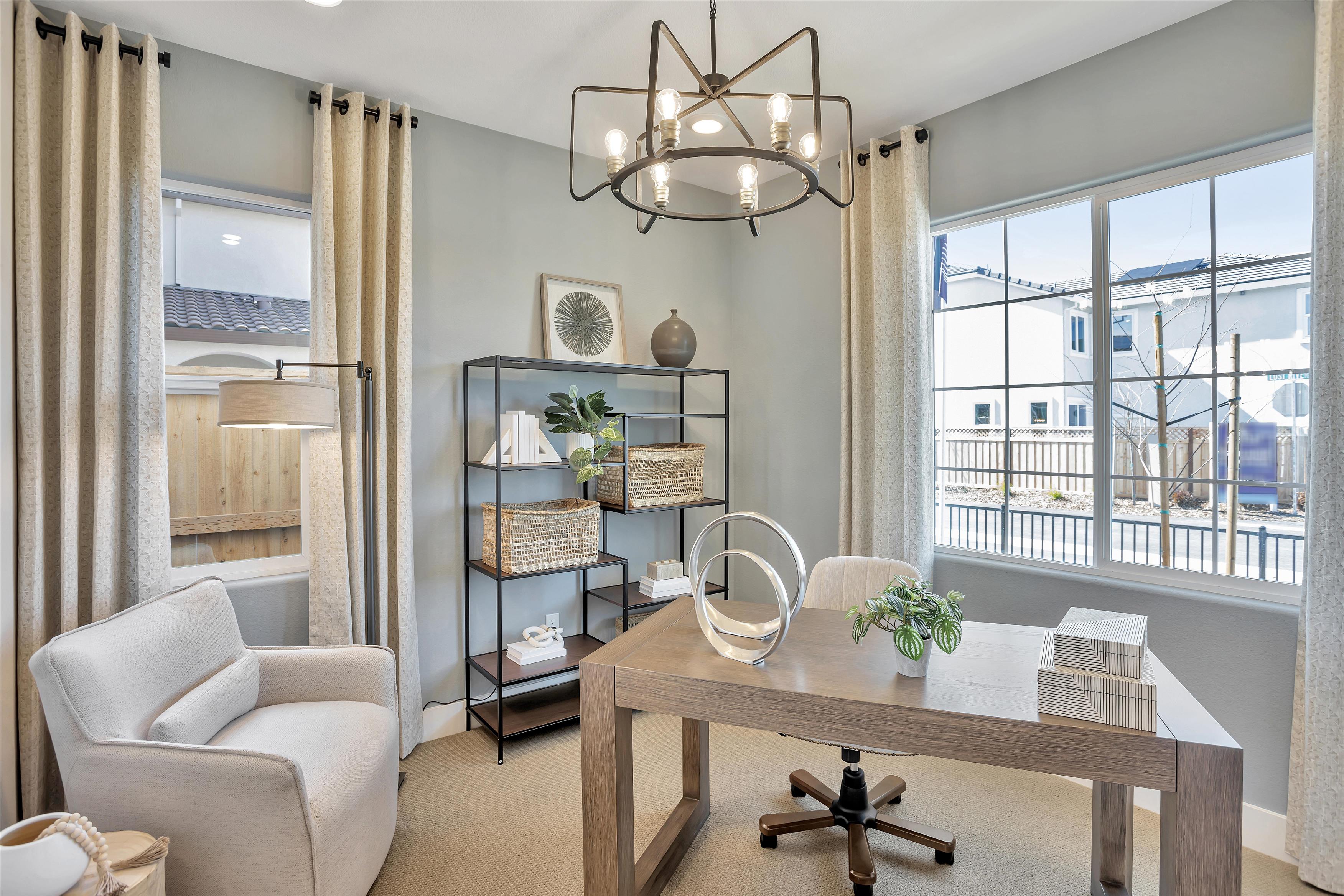 A living room with a table and chairs.