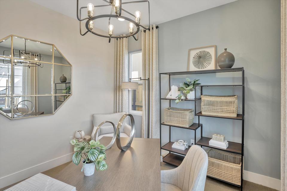 A room with a table and chairs.