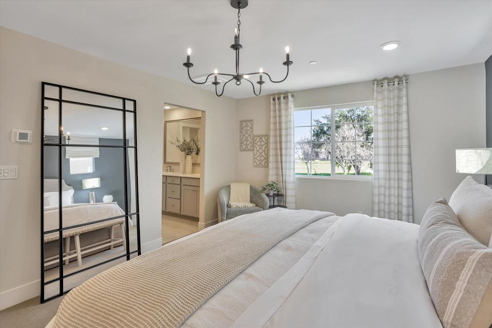 A bedroom with a large glass door.