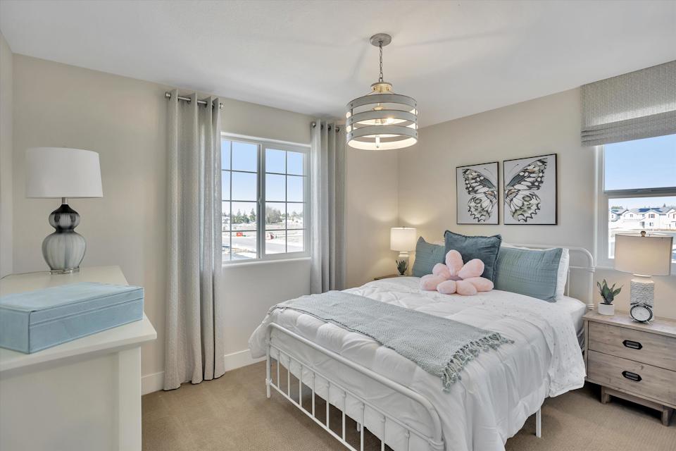 A bedroom with a bed and a window.