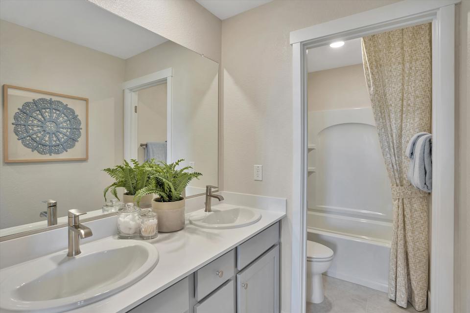 A bathroom with a sink and a shower.