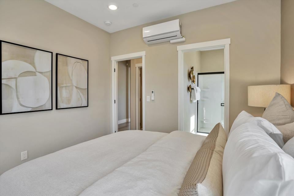 A bedroom with a bed and a mirror.