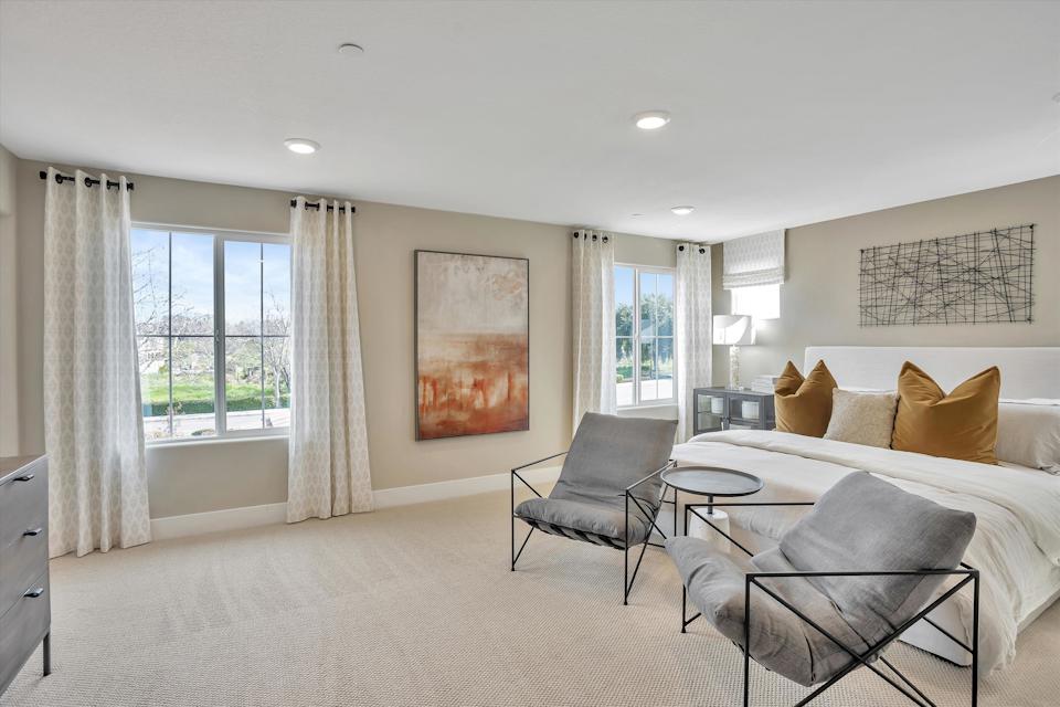 A room with a bed and a chair.