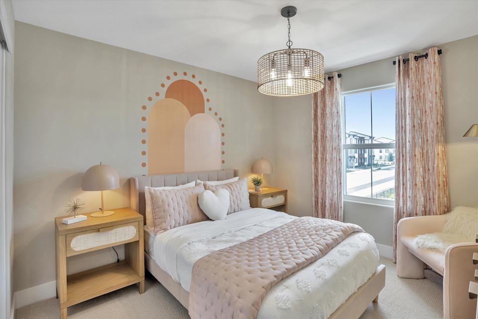 A bedroom with a large mirror.