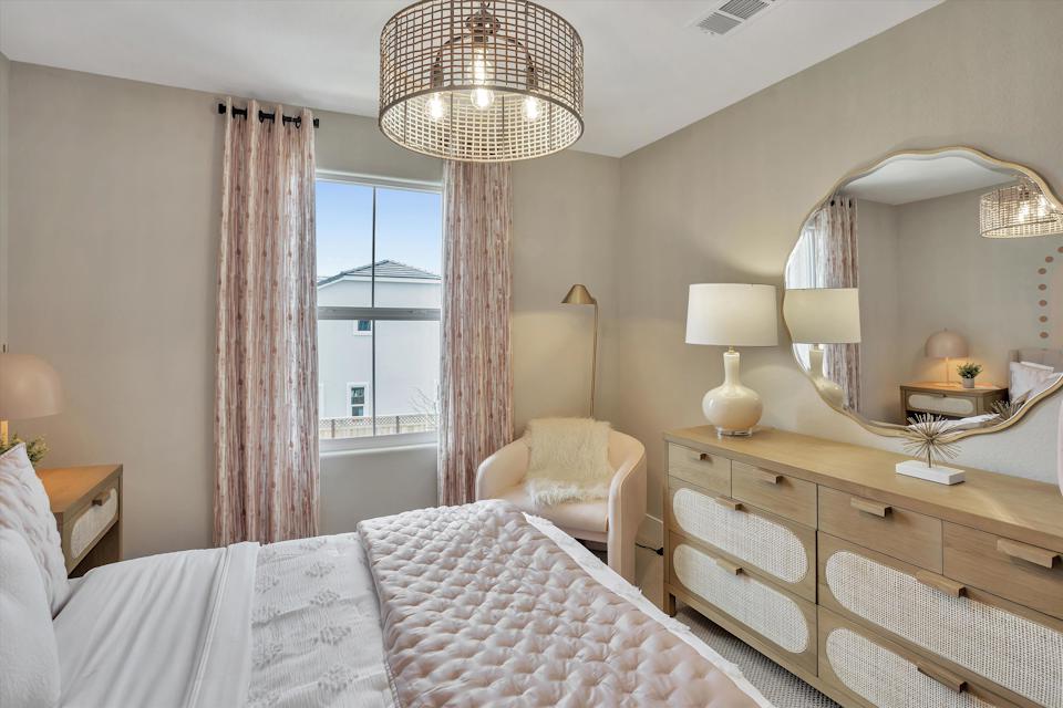 A bedroom with a large window.