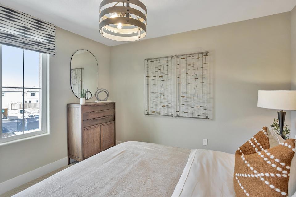 A bedroom with a large mirror.