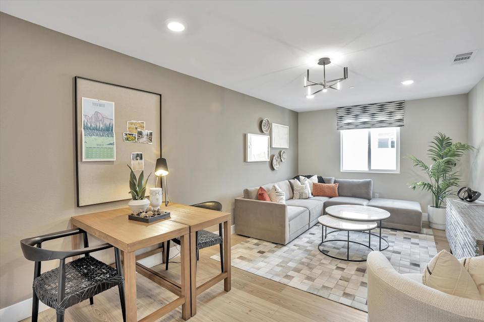 A living room with a table and chairs.