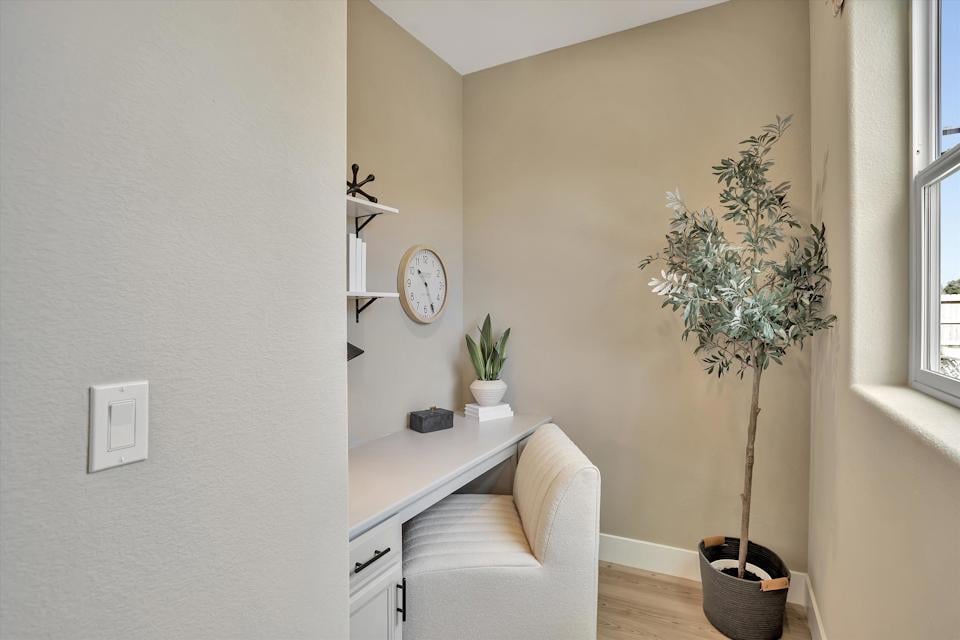 A room with a desk and a chair.