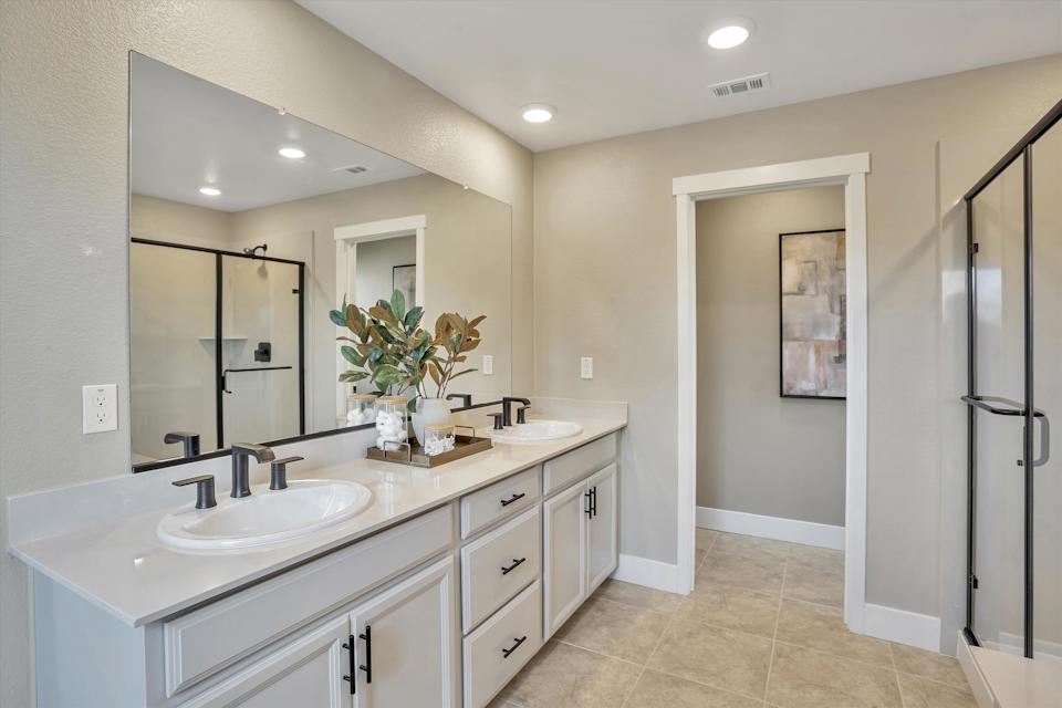 A bathroom with a large mirror.