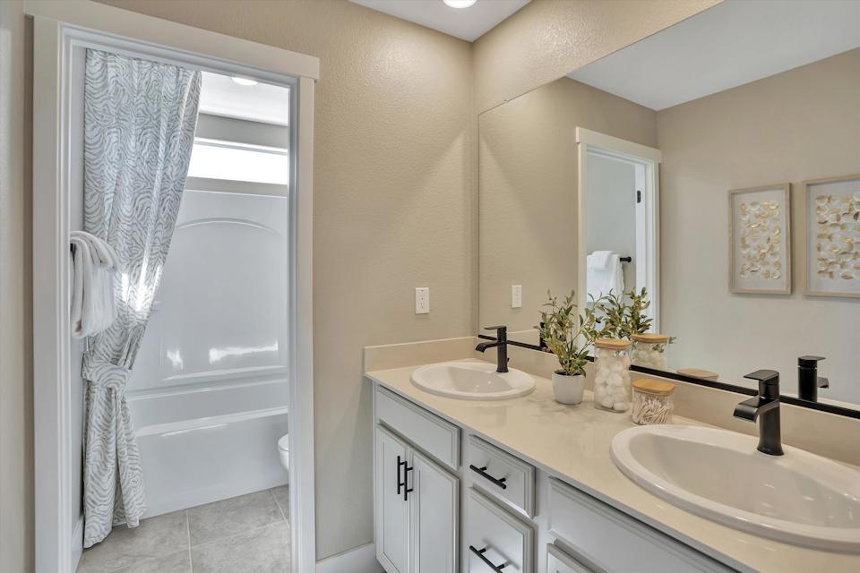 A bathroom with a sink and a shower.