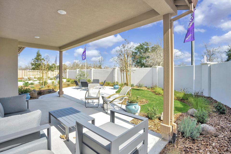 A patio with a table and chairs.