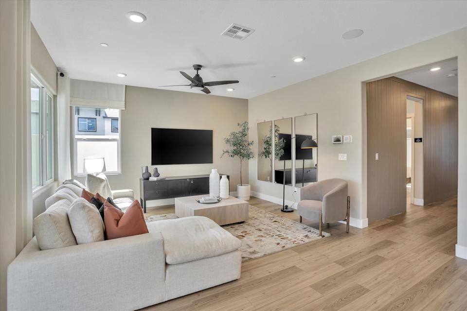 A living room with a wood floor.