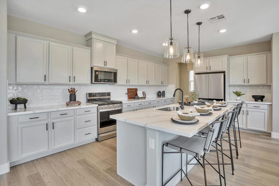 A kitchen with white cabinets.
