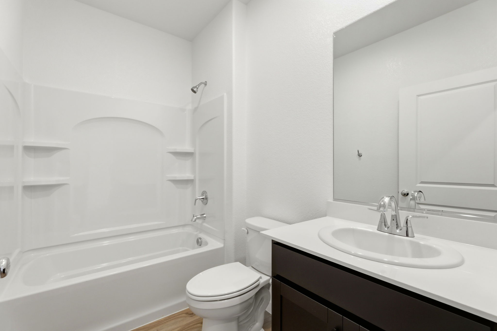 A bathroom with a tub sink and toilet.