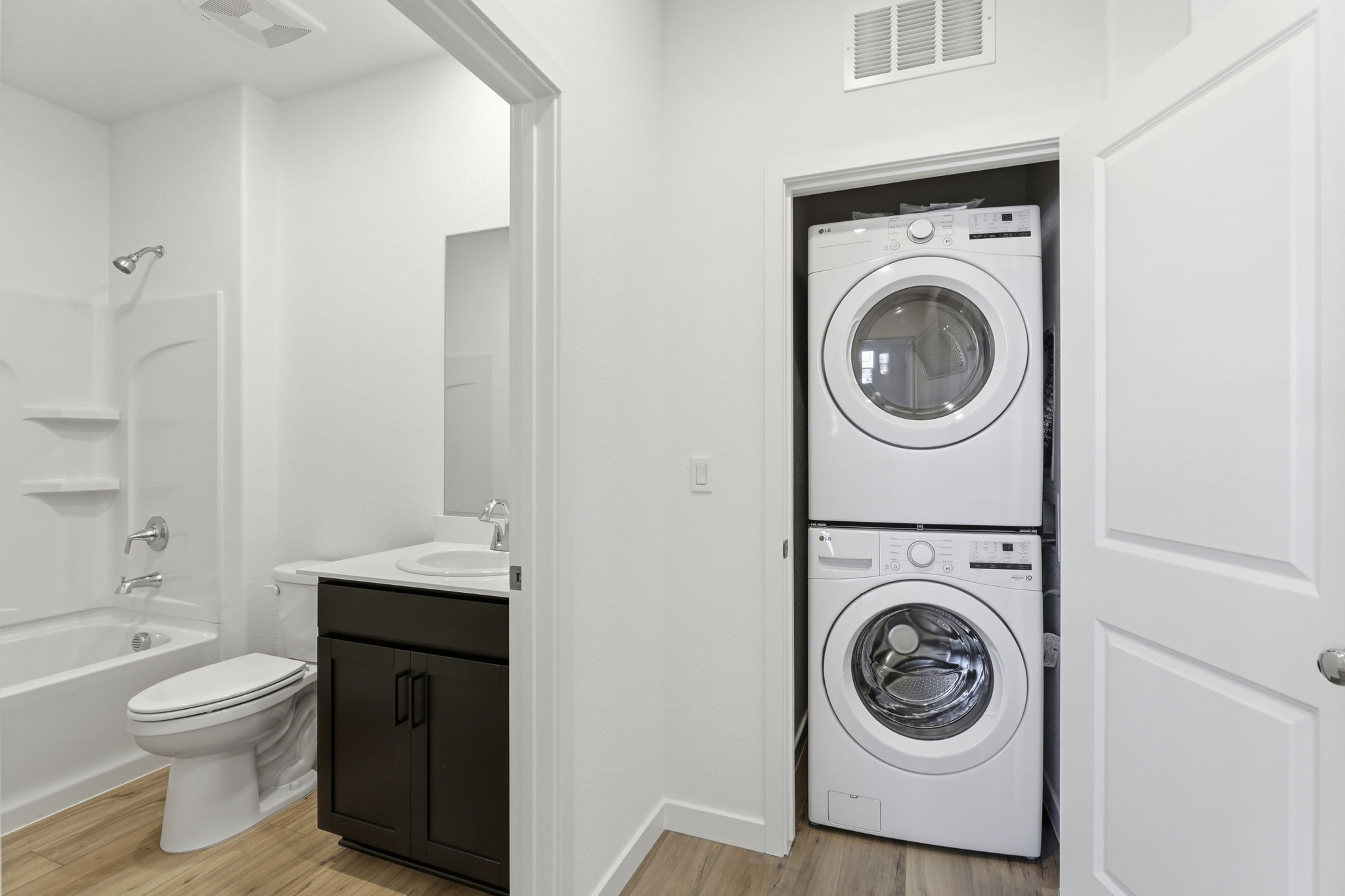 A bathroom with a washer and dryer.