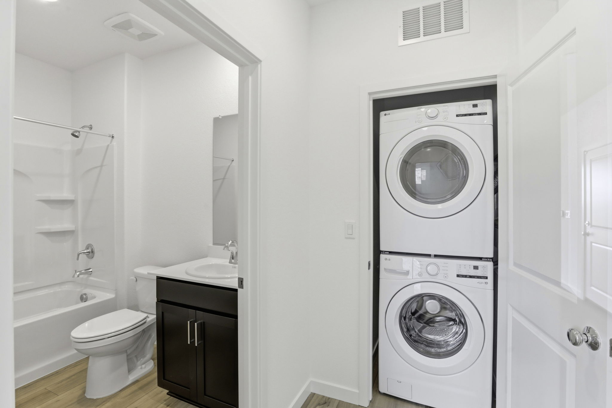 A bathroom with a washer and dryer.