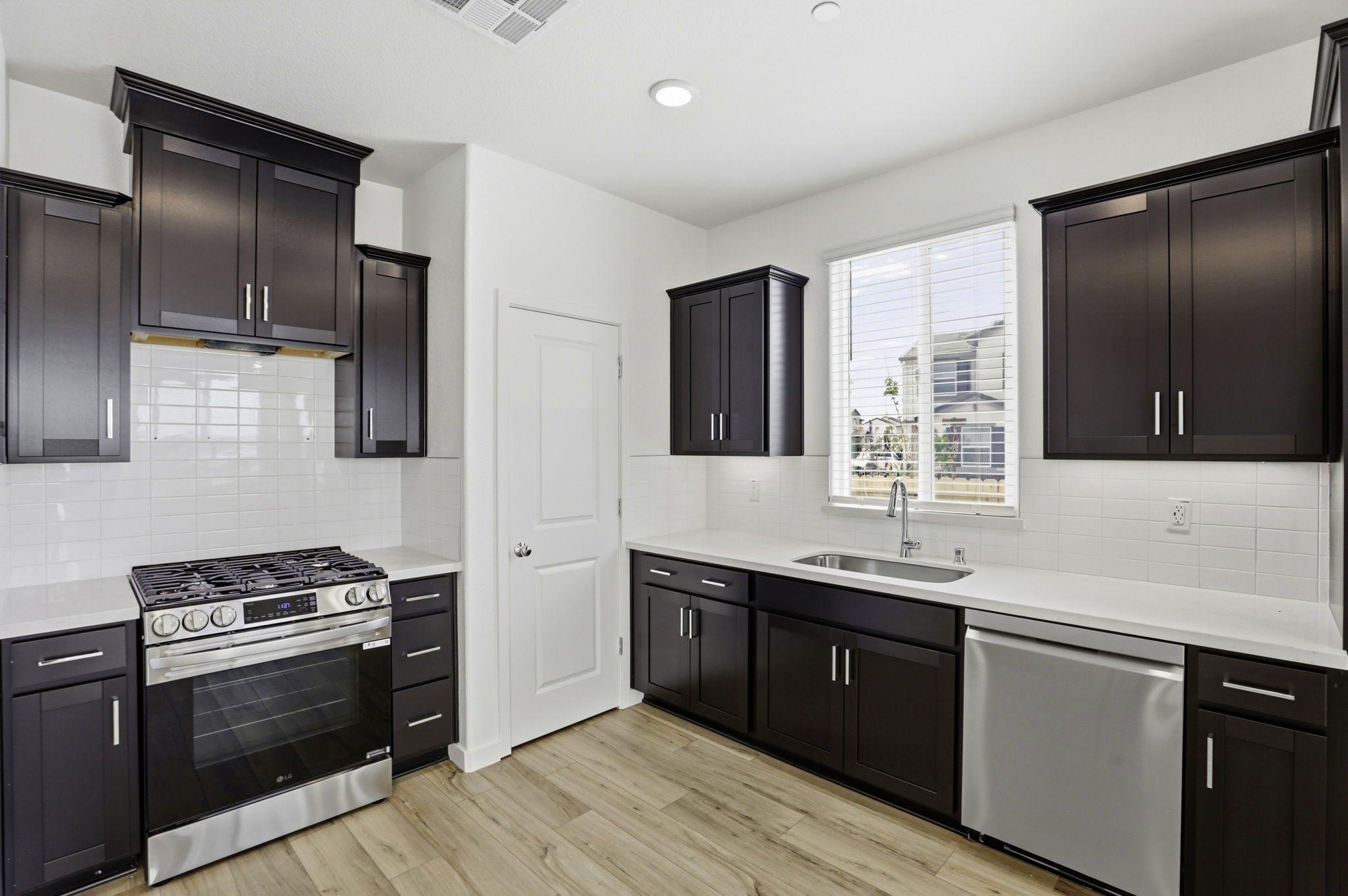 A kitchen with black cabinets.